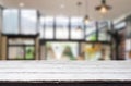 Wooden board empty Table Top And Blur Interior over blur in coffee shop Background, Mock up for display of product Royalty Free Stock Photo