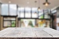 Wooden board empty Table Top And Blur Interior over blur in coffee shop Background, Mock up for display of product Royalty Free Stock Photo