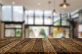 Wooden board empty Table Top And Blur Interior over blur in coffee shop Background, Mock up for display of product Royalty Free Stock Photo