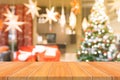 Wooden board empty table top on of blurred background. Perspective brown wood table over blur christmas tree background. Royalty Free Stock Photo