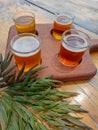 Wooden board with four glasses of beer.