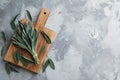 Wooden board with fresh green sage on grey table, flat lay. Space for text