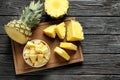 Wooden board with fresh sliced pineapple