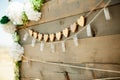 Wooden board with heart shaped garland and string lights - wedding welcome sign Royalty Free Stock Photo