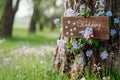 Wooden board with the inscription in paint Wedding. Sign for guests at the entrance, outdoors wedding ceremony decoration. Hand Royalty Free Stock Photo