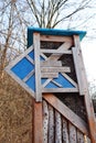 Wooden board on an insect hotel showing the way to the Korona Drzew in Poznan, Poland.