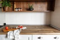 Wooden board with knife, tomatoes on modern kitchen countertop a Royalty Free Stock Photo