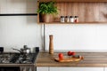 Wooden board with pepper mill, knife, tomatoes on modern kitchen Royalty Free Stock Photo