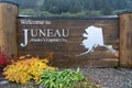 Wooden board sign with text: Welcome to Juneau. Alaska, United States.