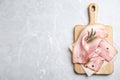 Wooden board with sliced raw bacon on light grey marble table. Space for text Royalty Free Stock Photo