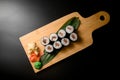 Wooden board sushi set with condiments Royalty Free Stock Photo