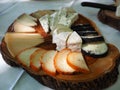 Wooden board with tasty assortment of cheese Royalty Free Stock Photo