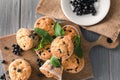 Wooden board with tasty blueberry muffins and fresh berries on table Royalty Free Stock Photo