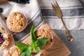 Wooden board with tasty blueberry muffins on grey table Royalty Free Stock Photo