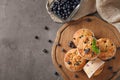 Wooden board with tasty blueberry muffins on table Royalty Free Stock Photo