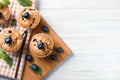 Wooden board with tasty blueberry muffins on table Royalty Free Stock Photo