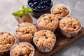 Wooden board with tasty blueberry muffins on table Royalty Free Stock Photo