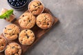 Wooden board with tasty blueberry muffins on table Royalty Free Stock Photo