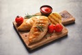 Wooden board with tasty grilled chicken breasts and garnish Royalty Free Stock Photo