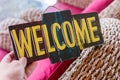 Wooden board with text welcome in man hand. Bali island. Welcome sign. Royalty Free Stock Photo