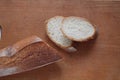 On a wooden Board there is a baguette and cut pieces of white bread baguette Royalty Free Stock Photo