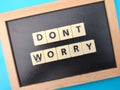 Wooden board and toys word with the word DONT WORRY