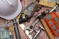 On a wooden board, a variety of tools needed for home repair are irregularly placed