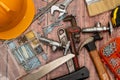 On a wooden board, a variety of tools needed for home repair are irregularly placed