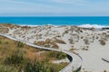 Wooden board walk over sand beach with ocean skyline