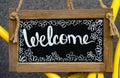 Wooden board with word welcome, signboard. Welcome sign, symbol