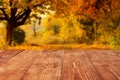 Wooden boards or desktop against blurred autumn forest landscape on background. Use as mockup for display or montage of Royalty Free Stock Photo