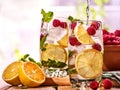 On wooden boards is glasses with raspberry mohito and jug. Royalty Free Stock Photo