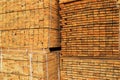 Wooden boards are piled in stacks at the yard of a construction supermarket. Industrial background, lumber, industrial wood. Pine