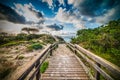 Wooden boardwalk in Alghero coastline at sunset