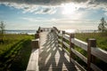 A wooden boardwalk beach access leads through meadow to an observation deck and Baltic beach. Royalty Free Stock Photo