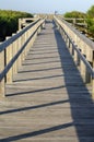 Wooden boardwalk on a beach at sunrise Royalty Free Stock Photo