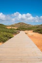 Wooden boardwalk in hilly dune landscape portugal Royalty Free Stock Photo