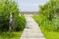 Wooden boardwalk leading to a sea coast Royalty Free Stock Photo