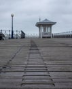 Wooden boardwalk with name plaques at Swanage Pier Dorset UK, photographed on a cold, windy autumn day.