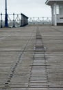 Wooden boardwalk with name plaques at Swanage Pier Dorset UK, photographed on a cold, windy autumn day.