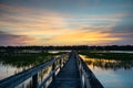 Wooden boardwalk over salt marsh during sunset Royalty Free Stock Photo
