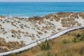 Wooden boardwalk sand beach over sea coast skyline