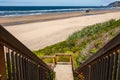 Wooden Boardwalk, Staircase Leading to Pacific ocean. Wooden staircase leading down to a beach in a sunny summer day Royalty Free Stock Photo