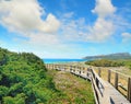 Wooden boardwalk under a cloudy sky in Capo Testa Royalty Free Stock Photo