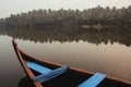 Wooden boat on the backwater canals on a background of tropical forest with palm trees. Copy, empty space for text