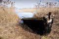 The wooden boat on the bank of the lake in the early spring Royalty Free Stock Photo