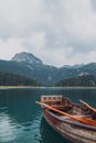 Wooden boat in Black lake at foggy early morning. Durmitor national park, Montenegro Royalty Free Stock Photo