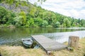 Wooden boat on the calm surface of the river Berunka near Zadni Treban island.