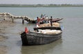 A wooden boat crosses a river in Gosaba, West Bengal, India