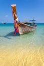 Wooden boat on crystal clear shallow water. Royalty Free Stock Photo